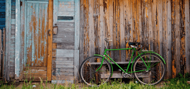 Old wooden wall and green bicycle